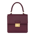 Luis Steven burgundy pebble leather small top handle bag with gold lock and detachable crossbody strap.